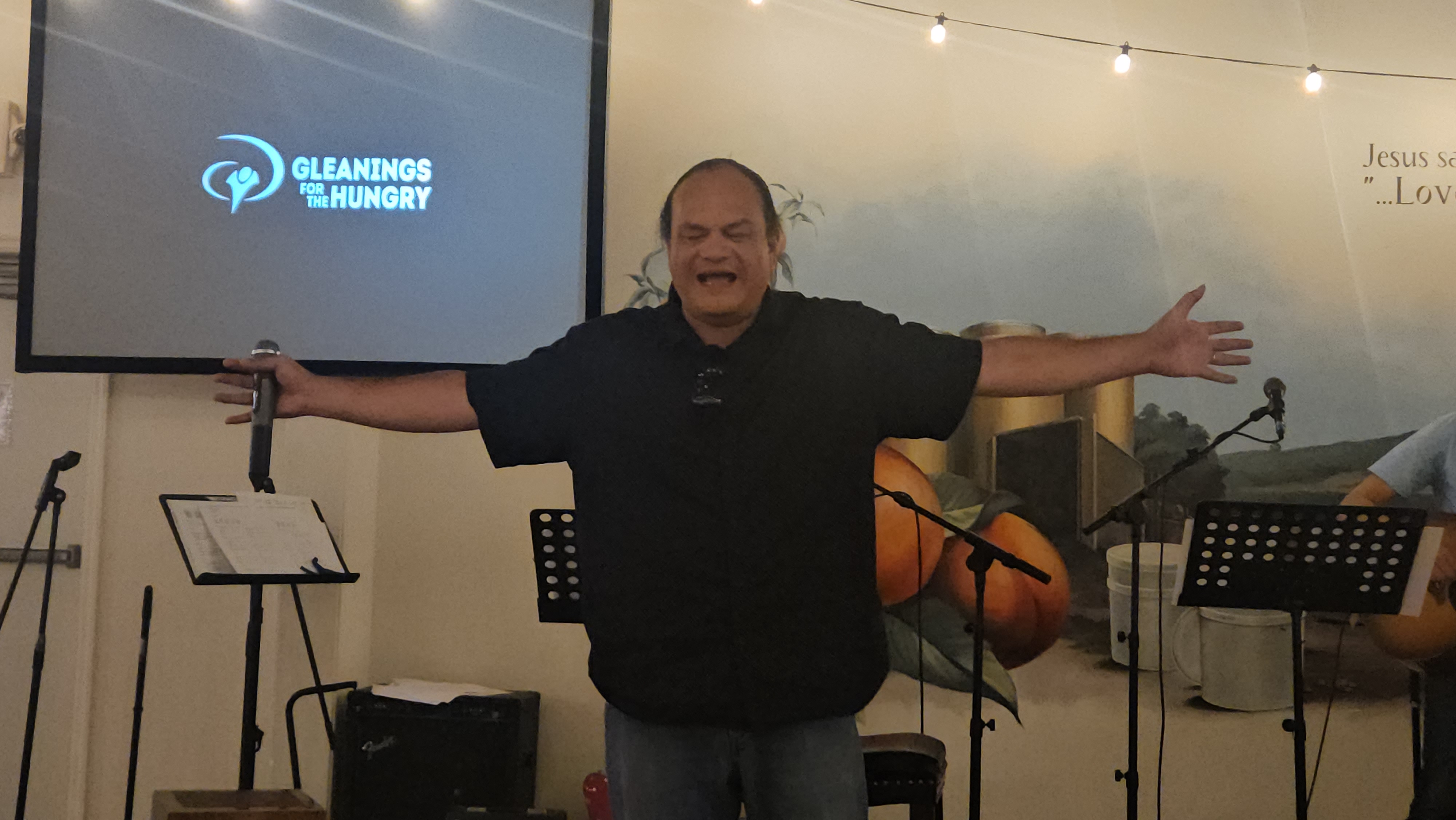Loto preaching at Gleanings for the Hungry